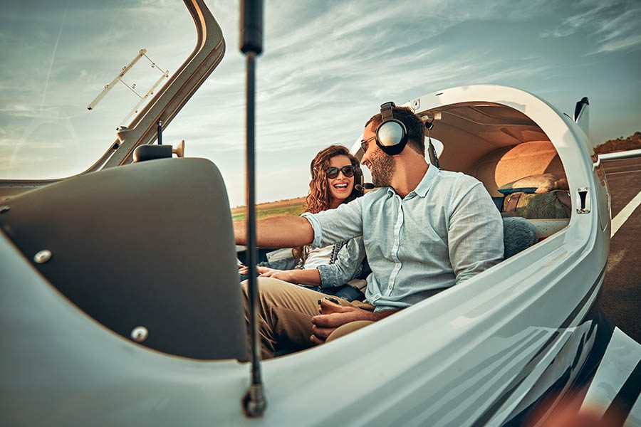 Specialized Business Insurance - Couple in a Small Private Airplane Getting Ready for Flight at Dusk